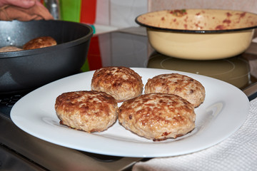 fried finished meat patties on a white plate standing on a table on a white towel. homemade fresh hearty wholesome food. cooks food at home. dinner.