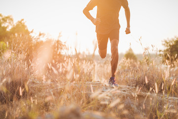Image of Athlete trail running, runner running on hill.