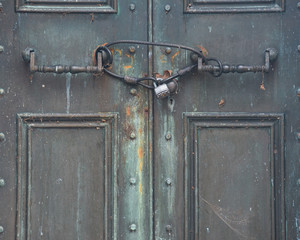 View of an old Antique Door locked with Rustic Vintage Padlock.
