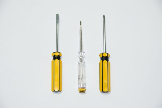 Different screwdrivers with handles, white and yellow.