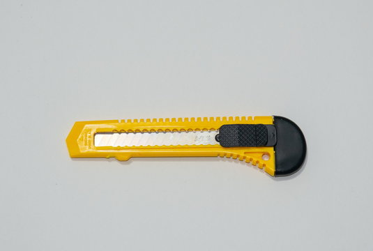 Knife cutter with yellow and black handle.