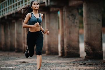 young woman runner running outdoors, Exercise for health.