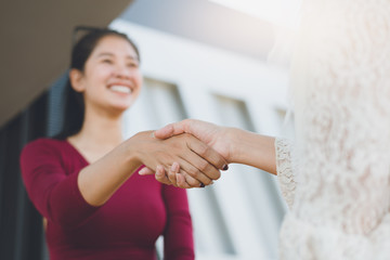 Obraz premium Negotiating business,Image of businesswomen Handshaking,happy with work,the woman she is enjoying with her workmate,Handshake Gesturing People Connection Deal Concept