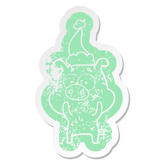 happy cartoon distressed sticker of a pig wearing santa hat