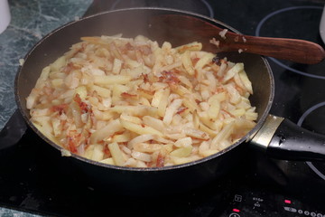 Fried potatoes in a saucepan.