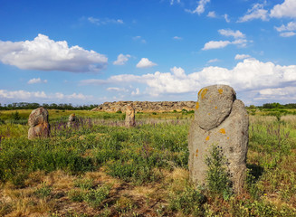 Landscape archaeological reserve Stone Grave or Rocky Mound Kamena Mohyla or Stone Tomb near Melitopo. Ukraine. Statue of a scythian warrior. Scythian Anthropomorphic stone sculpture. Statue in steppe