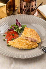 Homemade Ham and Cheese Omelette on wooden table