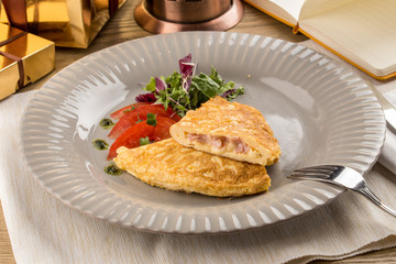 Homemade Ham and Cheese Omelette on wooden table