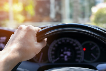 man hand holding control steering wheel of drive vehicle car