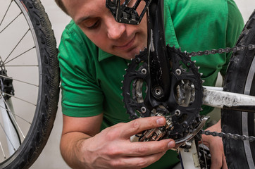 Master repairs bicycle in bicycle repair shop