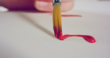 Macro shot of brush painting on paper with acrylic colors