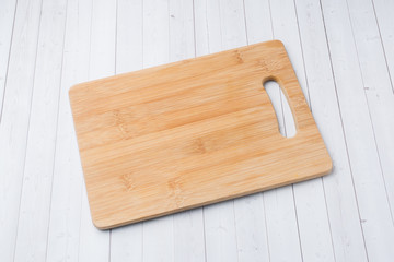 Empty wooden cutting board on a white background Copy space