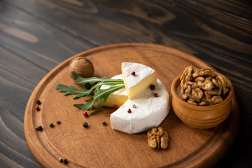 Cheese camembert or brie with walnuts and arugula