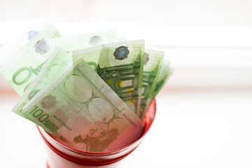 Moneybox, Euro bill in bucket on white window.light background. place for text. top view. a lot of...