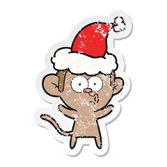 distressed sticker cartoon of a surprised monkey wearing santa hat