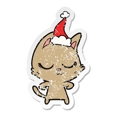 calm distressed sticker cartoon of a cat wearing santa hat