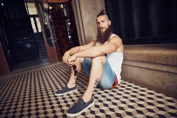Muscular young bearded man in staircase