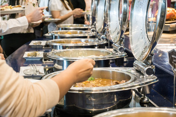 Close up hand of people take buffet food lunch meal