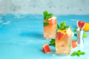 Grapefruit and mint gin tonic cocktail, refreshing drink with ice. Cold summer citrus refreshing...