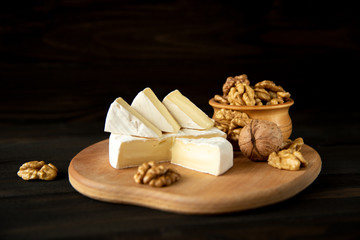 Fototapeta na wymiar Cheese camembert or brie with walnut kernels