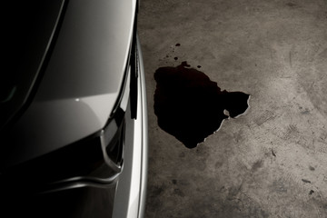 Oil leak or drop from engine of car on concrete floor , check and maintenance auto service