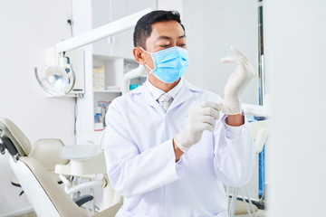 Professional dentist preparing for work