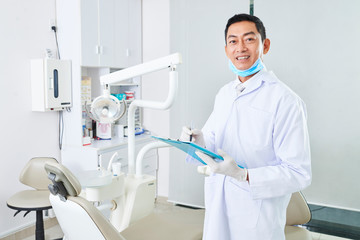 Mature dentist at his work