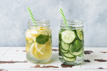 Detox water for healthy lifestyle. Fresh water in jar with lemon, cucumber and mint on wooden table.