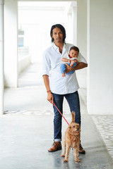 Man walking with baby and his pet