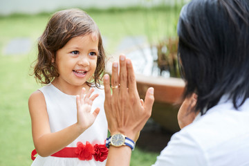 Little girl playing with father