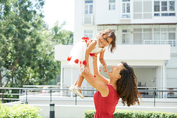 Mother playing with daughter outdoor