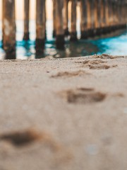 Sand with tracks near Manhattan beach pier in Los Angeles