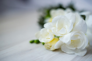 White freesia flowers on the board, different focus
