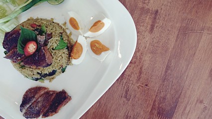 Traditional Thailand food, Kaw Pad Nam Prick Pra Salid or Stired fried rice with chilli paste, topping with deep fried fish, asian food decorative style concept 