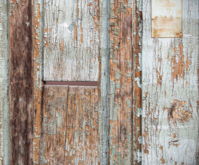 Texture of old wood use as natural background. Wooden background. Remnants of old paint on the doors