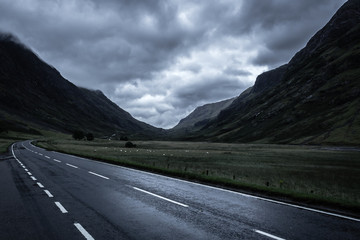 Dark clouds over road through Glen Coe