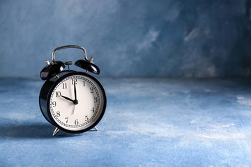 Alarm clock on color background