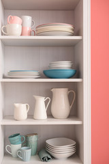 Fototapeta na wymiar Set of clean dishes on shelves