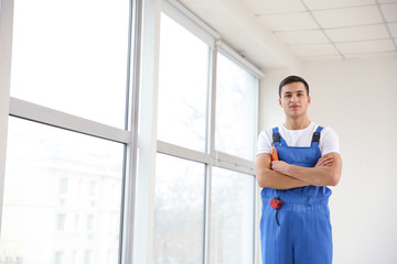 Young worker in room with big windows