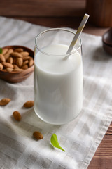Glass of healthy almond milk on table