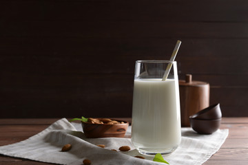Glass of healthy almond milk on table