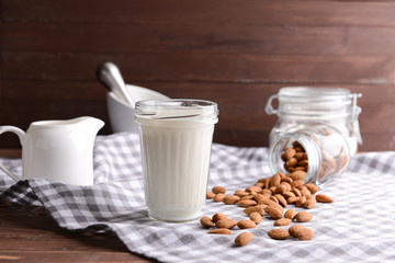 Glass of healthy almond milk on table