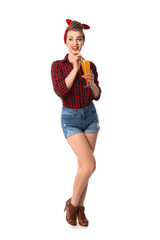 Beautiful pin-up woman with cocktail on white background