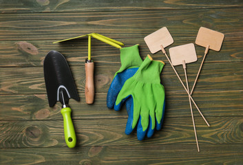 Composition with gardening tools on wooden background