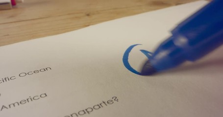 Macro shot of teacher marking a score on a school test