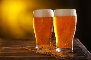 Glasses of fresh beer on table