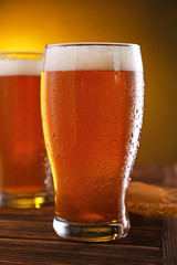 Glasses of fresh beer on table