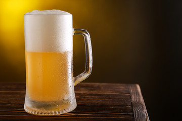 Mug of fresh beer on table