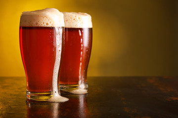 Glasses of fresh beer on table
