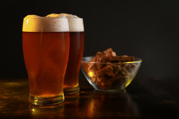 Glasses of fresh beer on table